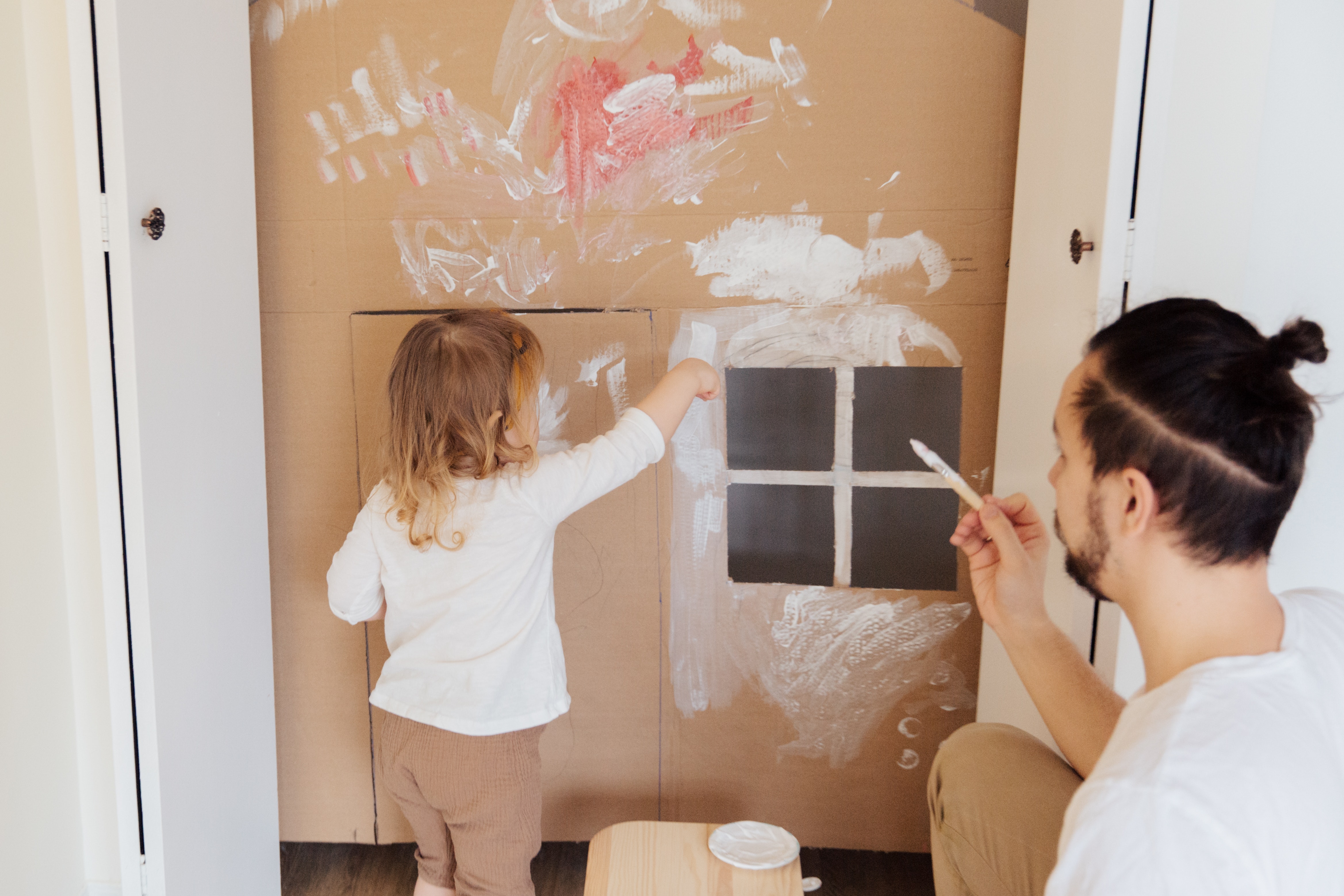 child painting cardboard