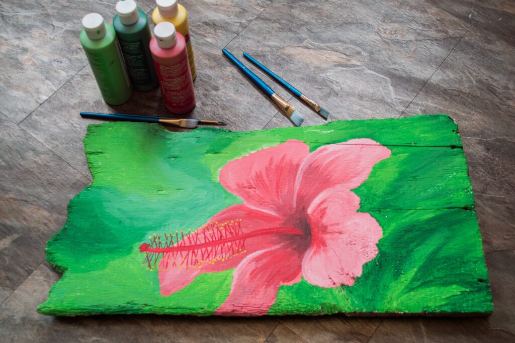 beautiful flower painted on wood plank with acrylics
