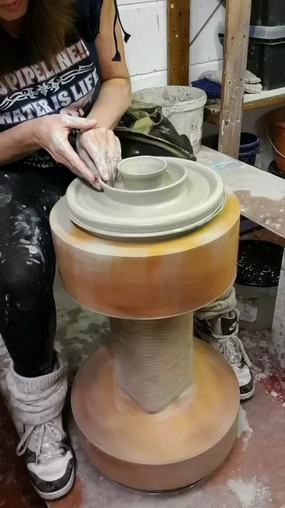 making 3 tier clay platter on pottery kick wheel