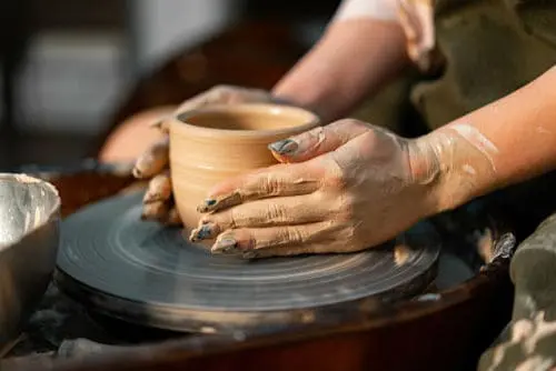 making pot on pottery wheel with long nails