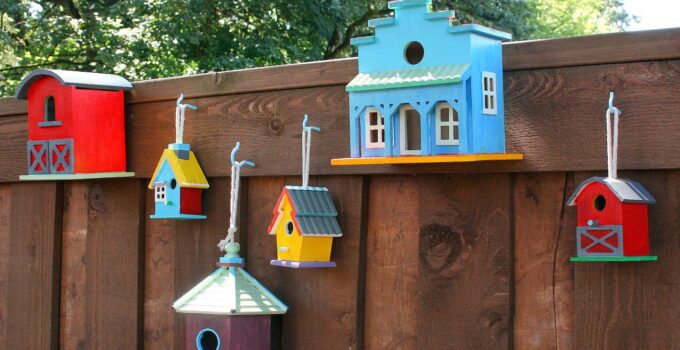 unique bird house painted design on yard fence